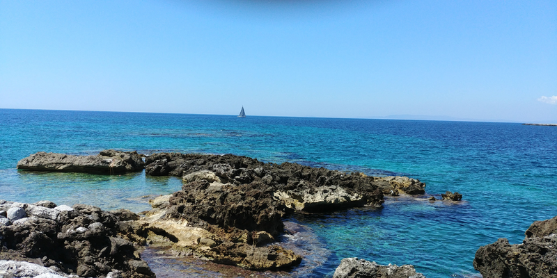 Sea salt harvesting coastline with rocky shore and blue ocean