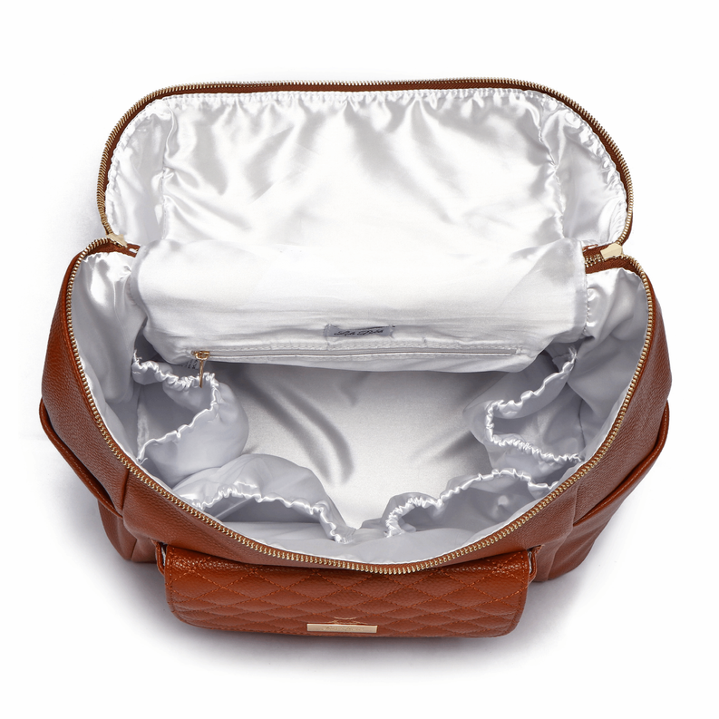 Caramel brown diaper bag open interior with white lining and zippered access top.