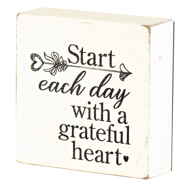 Tabletop plaque with “Start each day with a grateful heart” printed in black