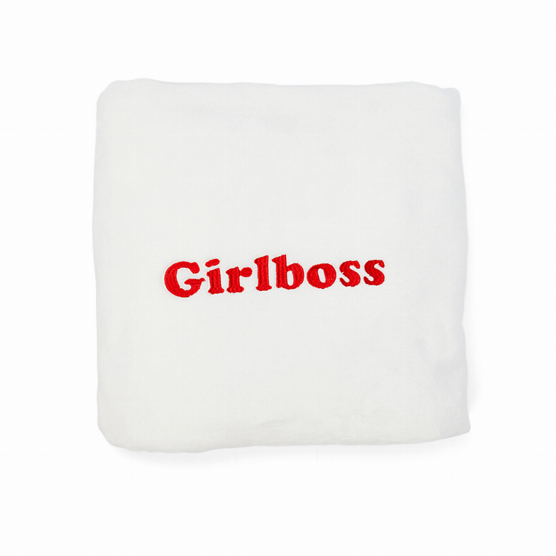 Girlboss plush fleece nap blanket, white, folded with red logo
