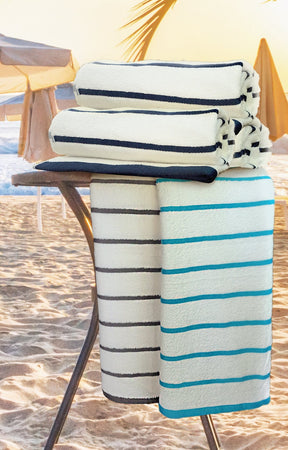 2-pack pool towels, white with navy and teal horizontal stripes, rolled stack