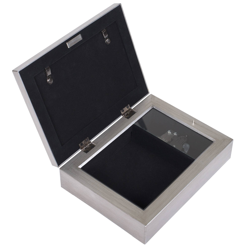 Silver filigree music box open lid showing black velvet-lined interior