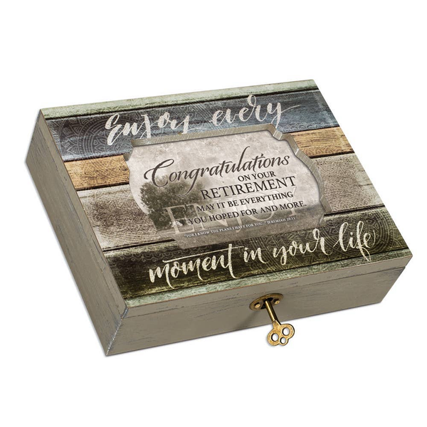 Retirement music box with engraved congratulatory text on a wood-look lid and key handle