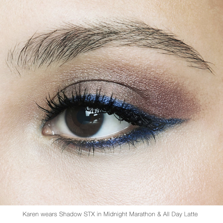 Eyelid makeup look with shimmery taupe and dark blue winged eyeliner