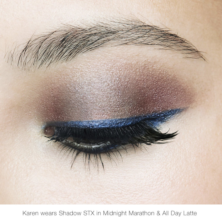 Eyelid makeup look with shimmery bronze-taupe lid and blue-black lash line