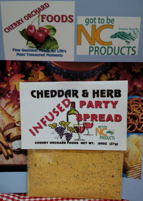 Cheddar & herb party spread container with white label and yellow infused spread