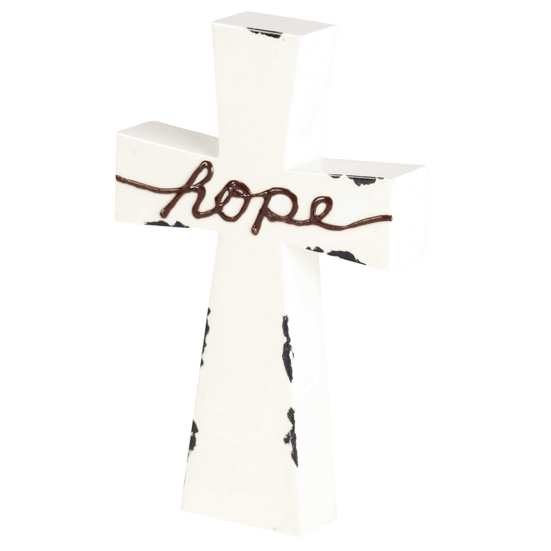 White tabletop cross centerpiece with brown Hope lettering across the arms, black speckles.