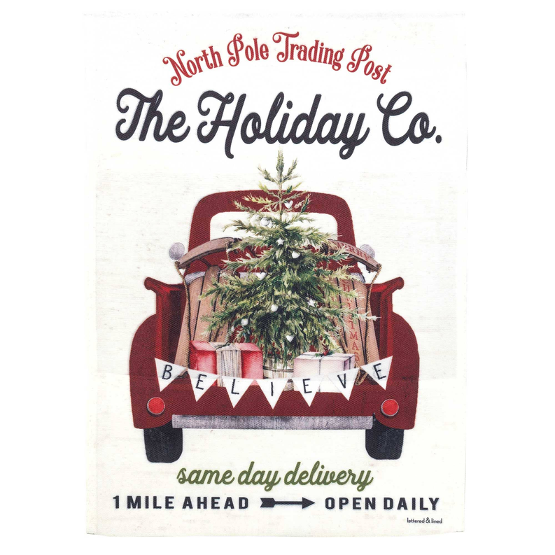 Holiday truck garden flag with evergreen tree and wreath in maroon truck bed