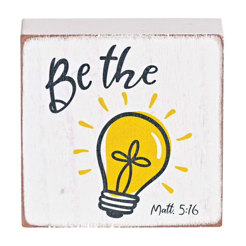 Tabletop plaque: 'Be the light' text with yellow lightbulb and 'Matt. 5:16'