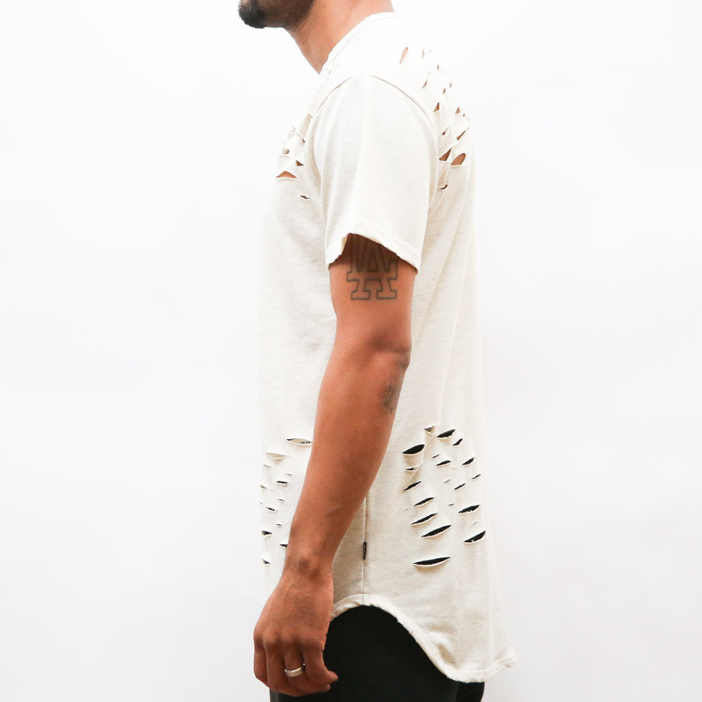 Distressed sand T-shirt, side view with large curved rip at the hem