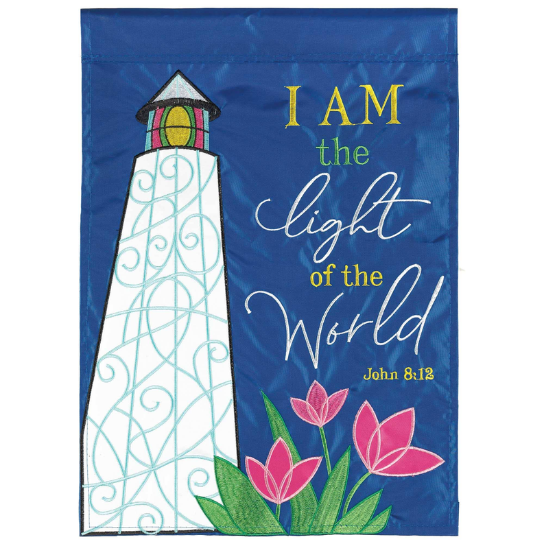 Fabric flag with lighthouse applique, flowers, and 'I am the light of the World'—8:12.