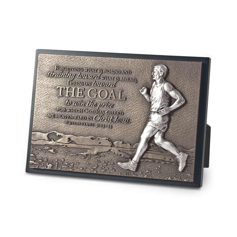 Dark faith runner sculpture plaque with relief figure and quote reading “THE GOAL”