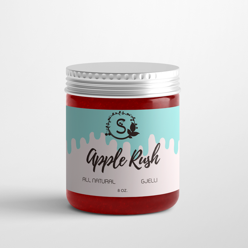 Scented candle jar with red wax, teal label, and silver metal lid