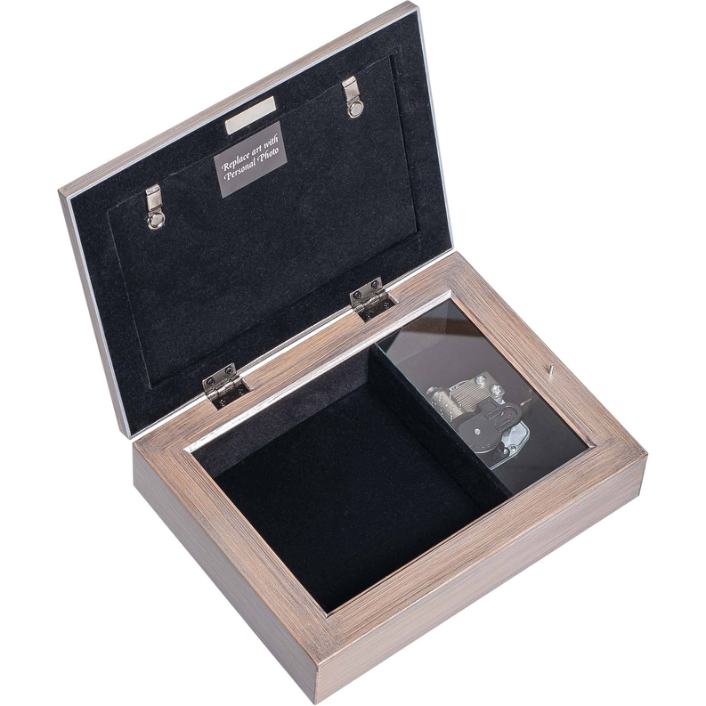 Wood and silver music box open to black-lined interior with music mechanism