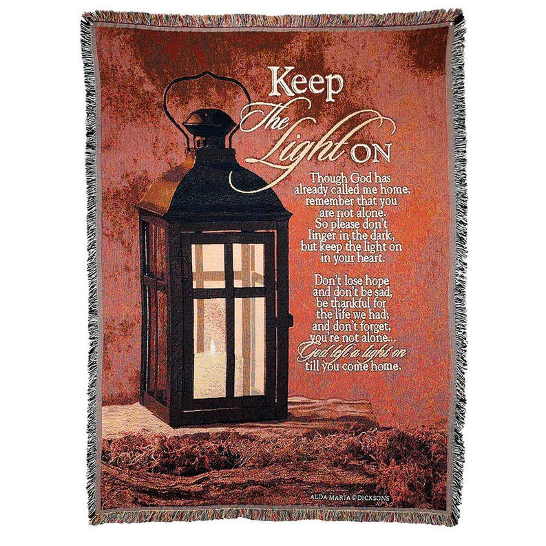 Square tapestry throw with fringed edges, dark lantern graphic and Keep The Light On text.