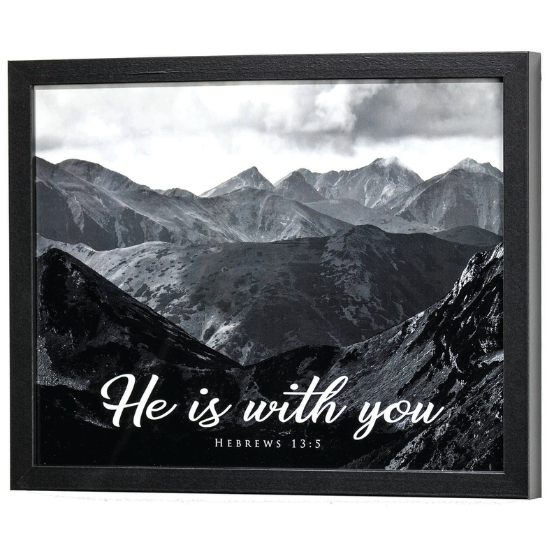 Framed mountain wall art with white script text "He is with you"