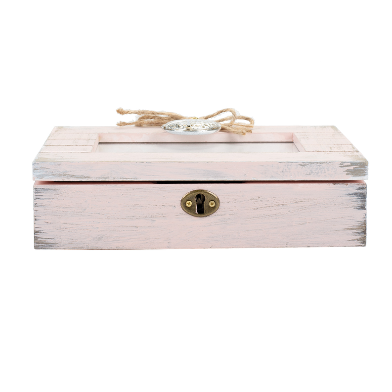 Pink distressed wooden music box with brass lock plate and locket medallion on top.