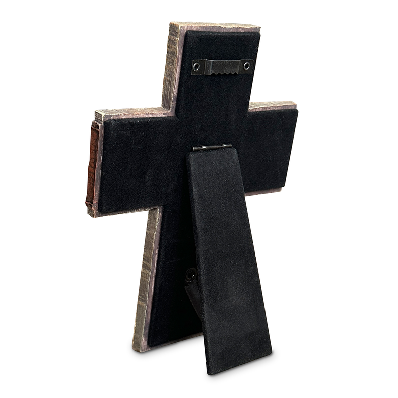 Cross-shaped black fabric ornament with metal studs and a strap loop