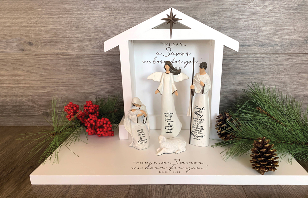 Four-piece nativity Holy Family set in a white stable display with angel and figures