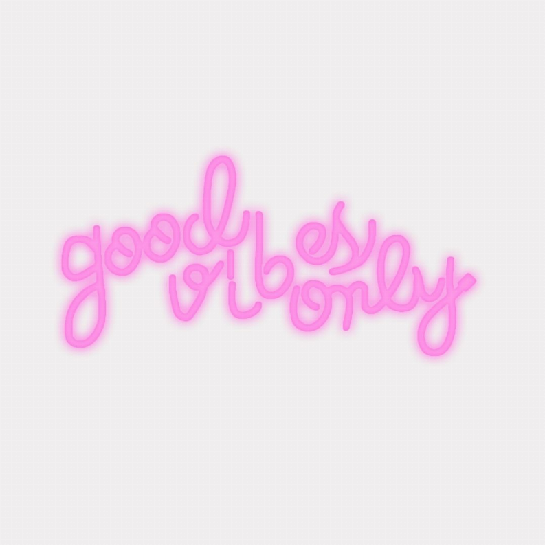 Pink glowing “Good Vibes Only” LED neon sign in cursive script.