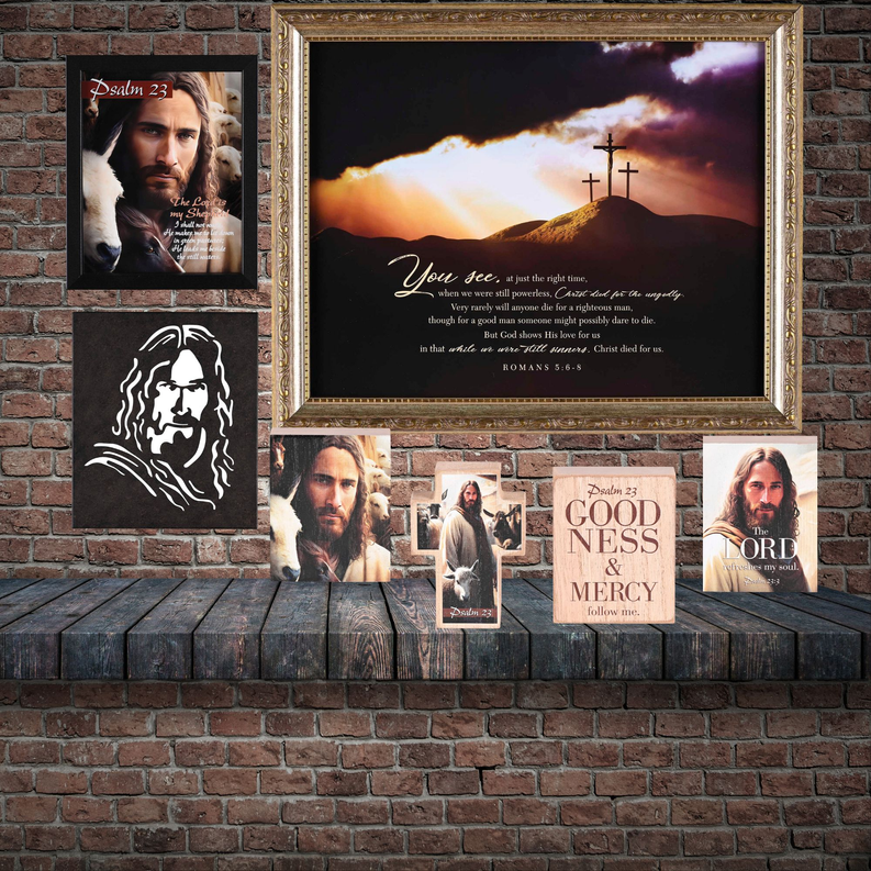 Framed wall art on brick wall with sunset mountain scene, crosses, and scripture lettering