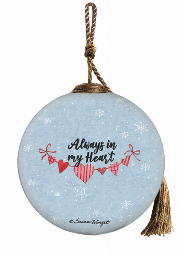 Round blue glass snowman ornament with red heart message, hanging with twine and tassel