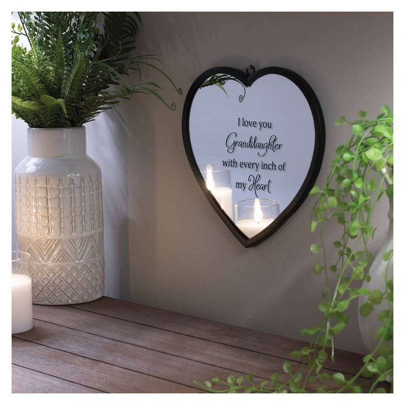Heart-shaped wall mirror with black border and candlelight reflection, granddaughter message.