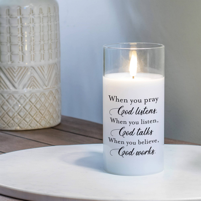 LED candle with clear glass and white wax; 'When you pray' text on front.