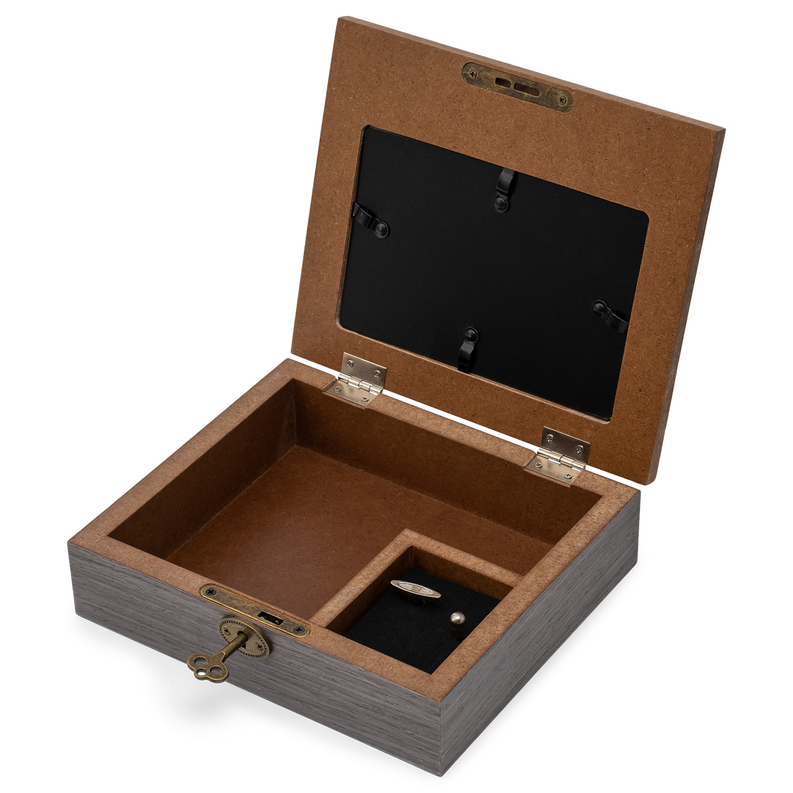 Open wooden music box with black interior and compartments for keepsakes.