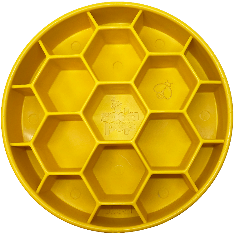 Yellow honeycomb slow feeder bowl interior showing embossed icons on hex cells