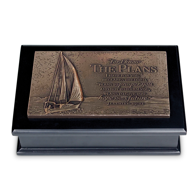 Open black sculpture box with sailboat scripture plaque on display insert