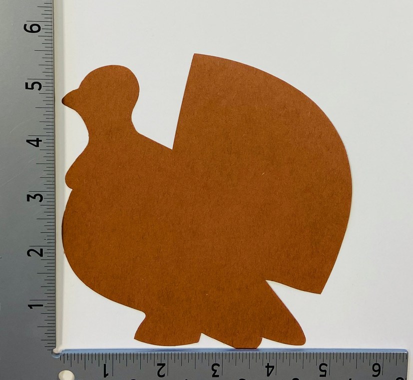 Brown paper chicken cut-out on white background, size shown beside a measuring ruler