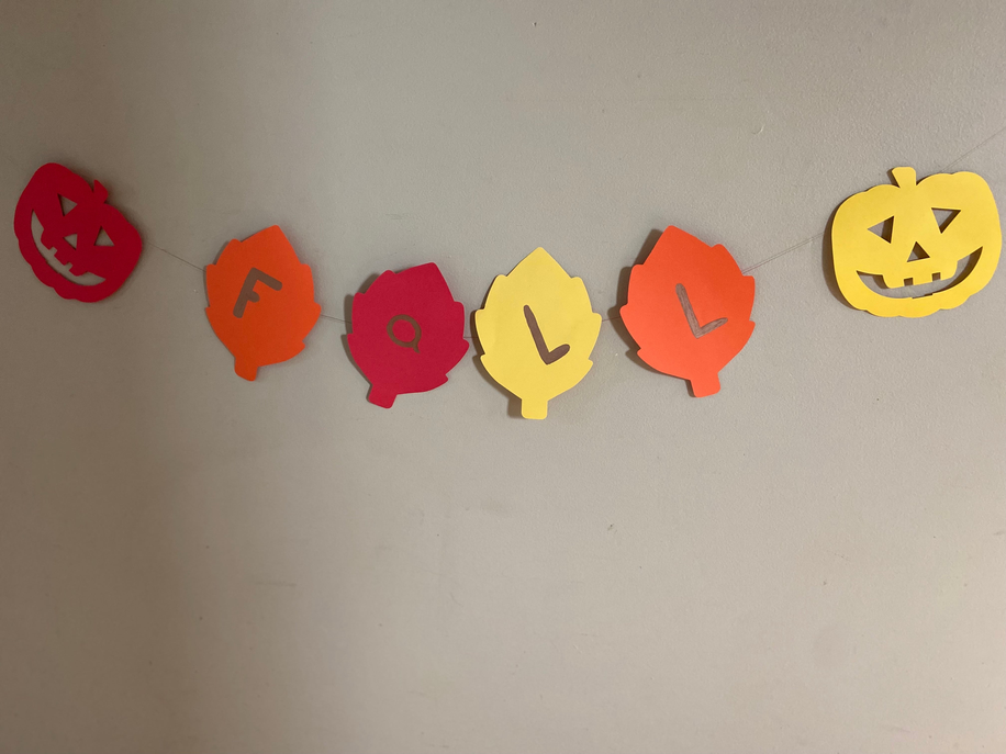 Assorted colorful Halloween cut-outs: jack-o’-lantern faces and small bat shapes in a row