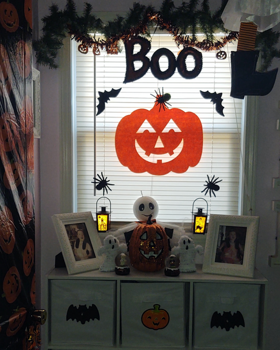 Large orange pumpkin foam cut-out on Halloween mantel display