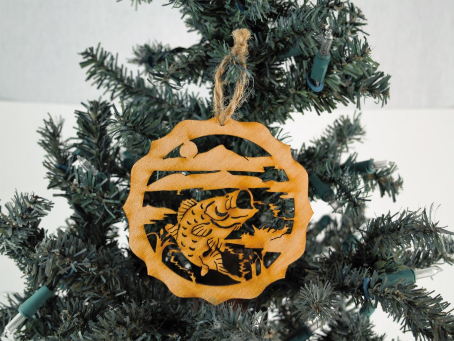 Unfinished wooden tree ornament, bass fish silhouette in circular cutout with hanging twine