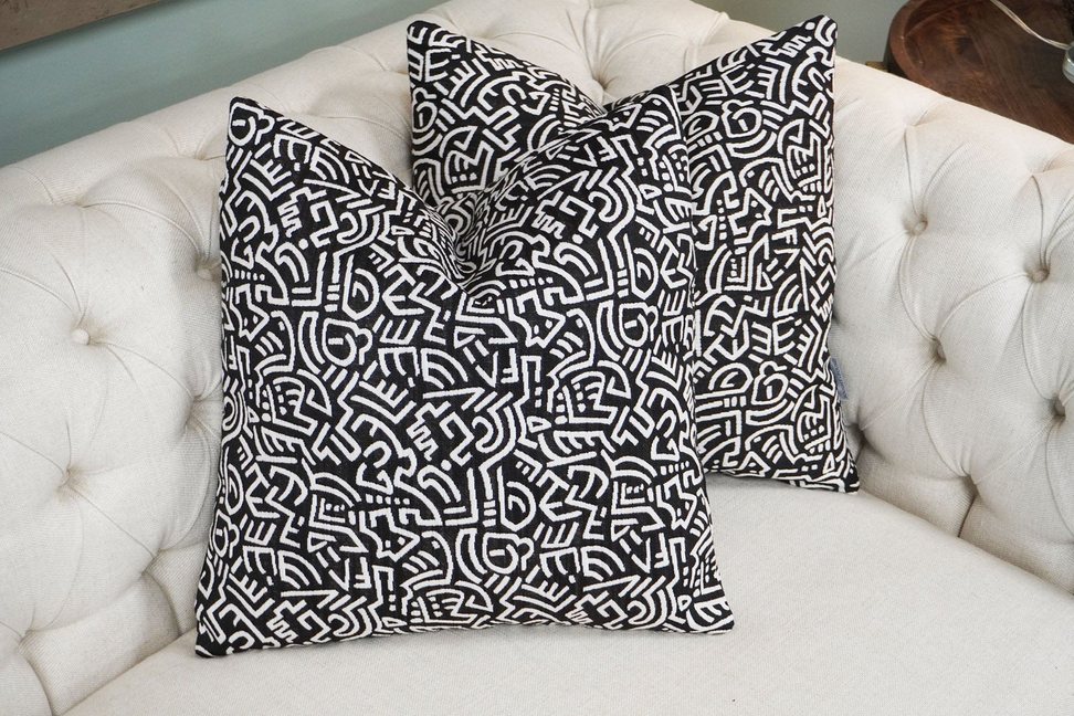 Pop Energy throw pillow in black with white abstract line maze pattern