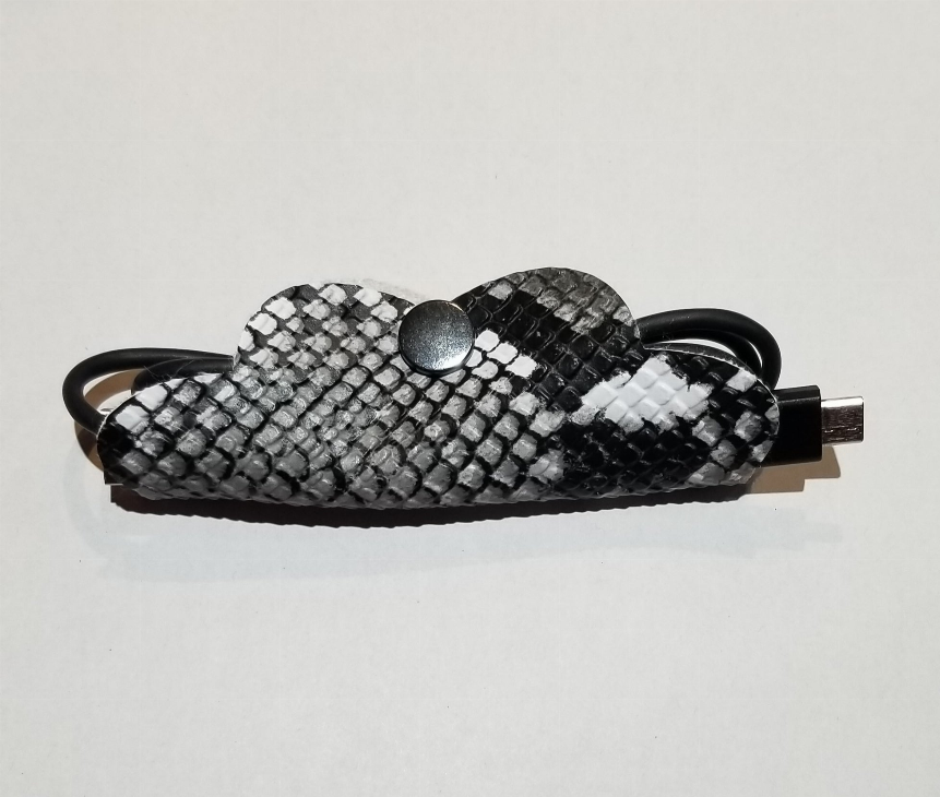 Braided cord organizer pouch with metal snap, black/gray/white, with cable plugs