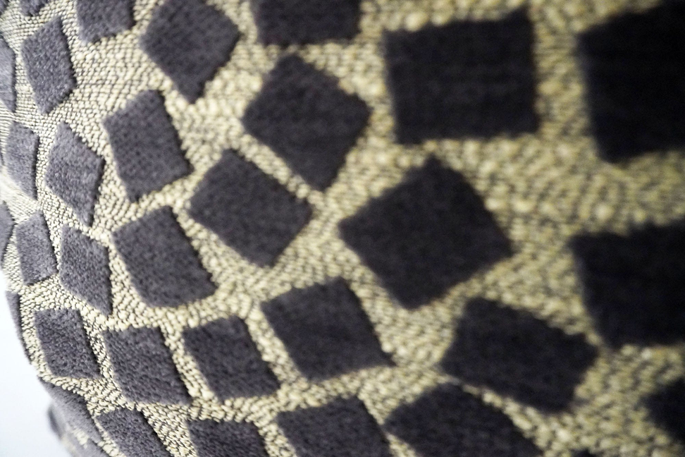 Black and beige geometric throw pillow fabric with repeating square motif