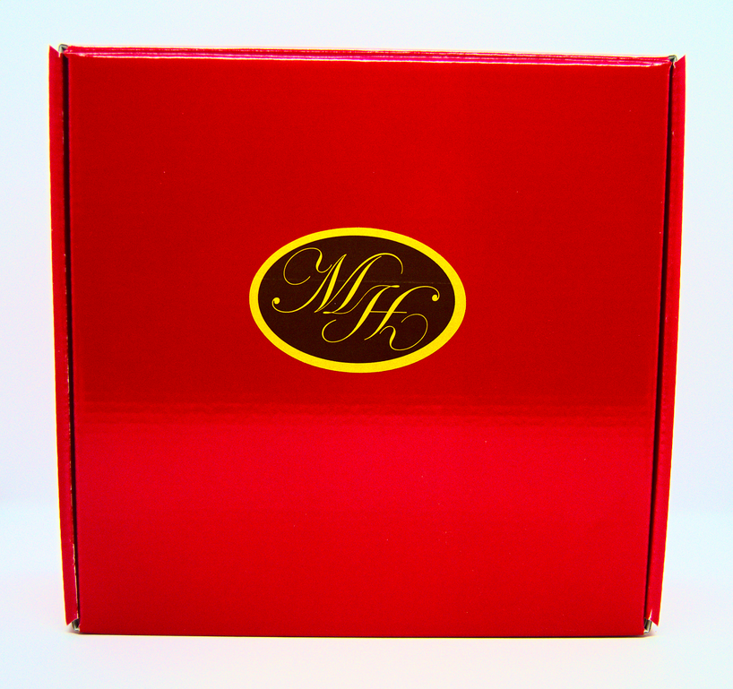 Red gift set box with gold monogram logo on the lid