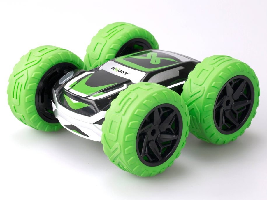 Green and white stunt toy car with oversized treaded wheels, angled three-quarter view