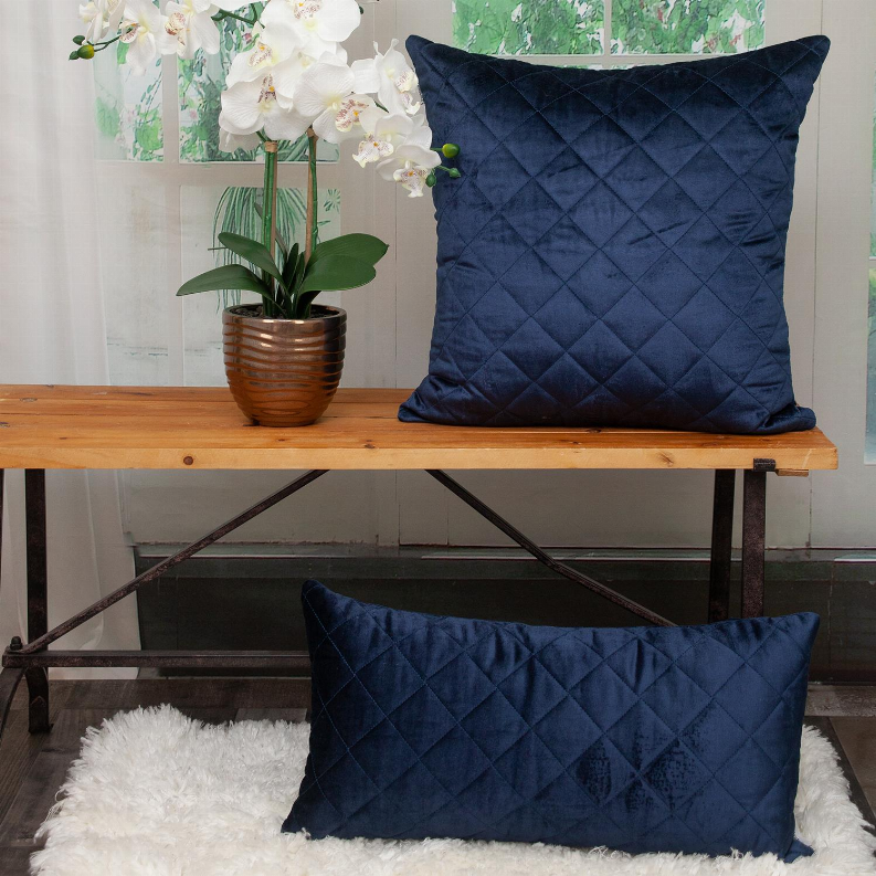 Navy quilted throw pillow with diamond stitching, front view with folded base edge