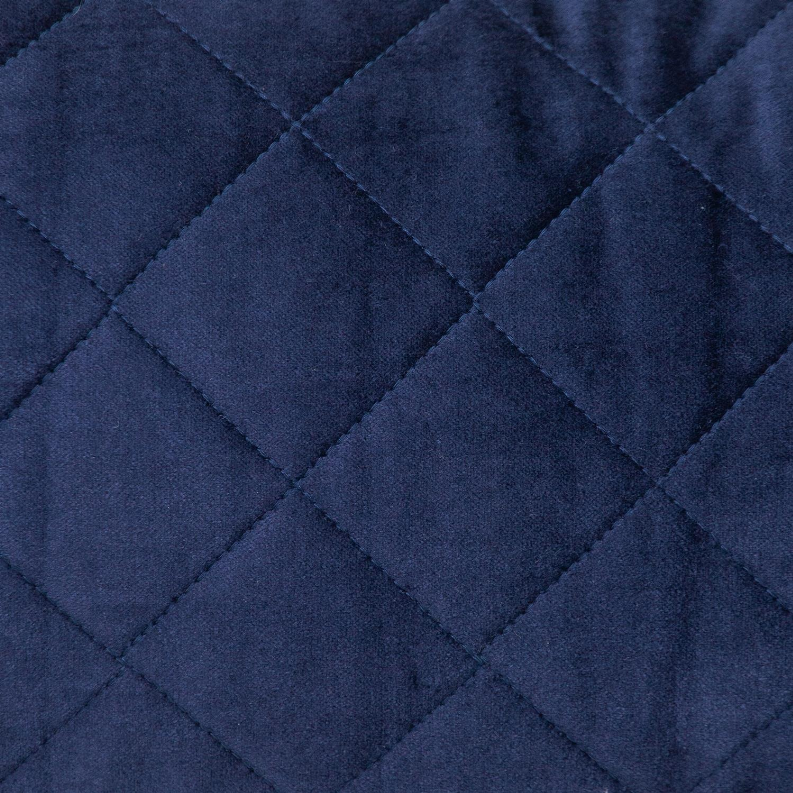 Close-up of navy quilted throw pillow with diamond stitching and textured fabric.