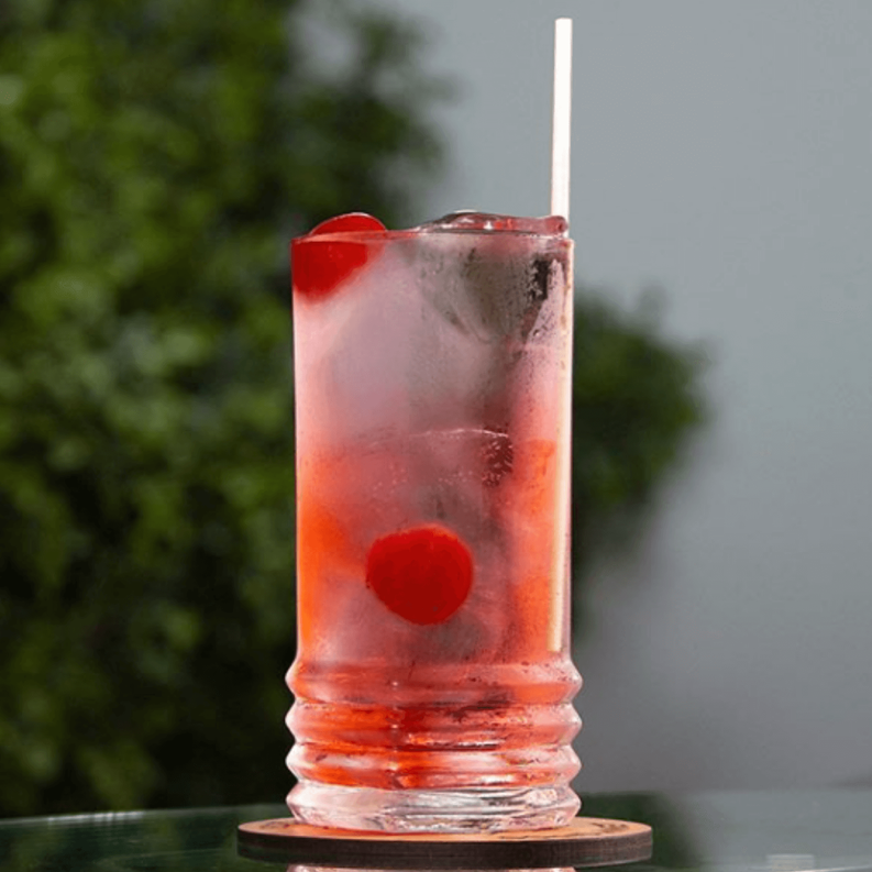 Tall wheat stem drinking straws in an iced drink, light tan.