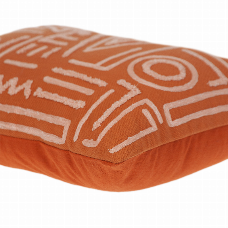 Orange decorative pillow corner with white geometric outline embroidery
