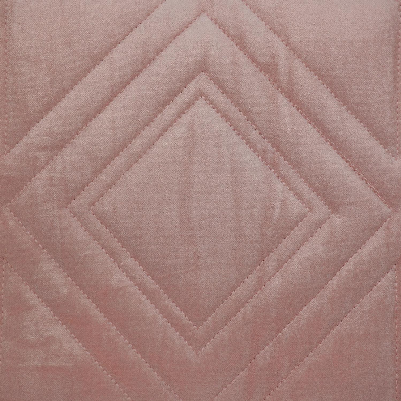 Pink quilted throw pillow close-up with diamond center and crisscross stitching