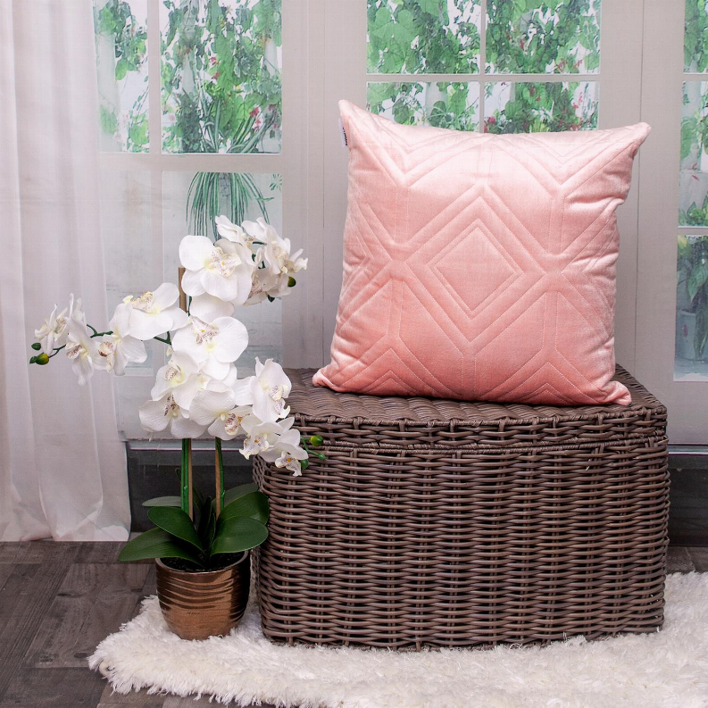 Pink quilted throw pillow with raised diamond and chevron quilting on front