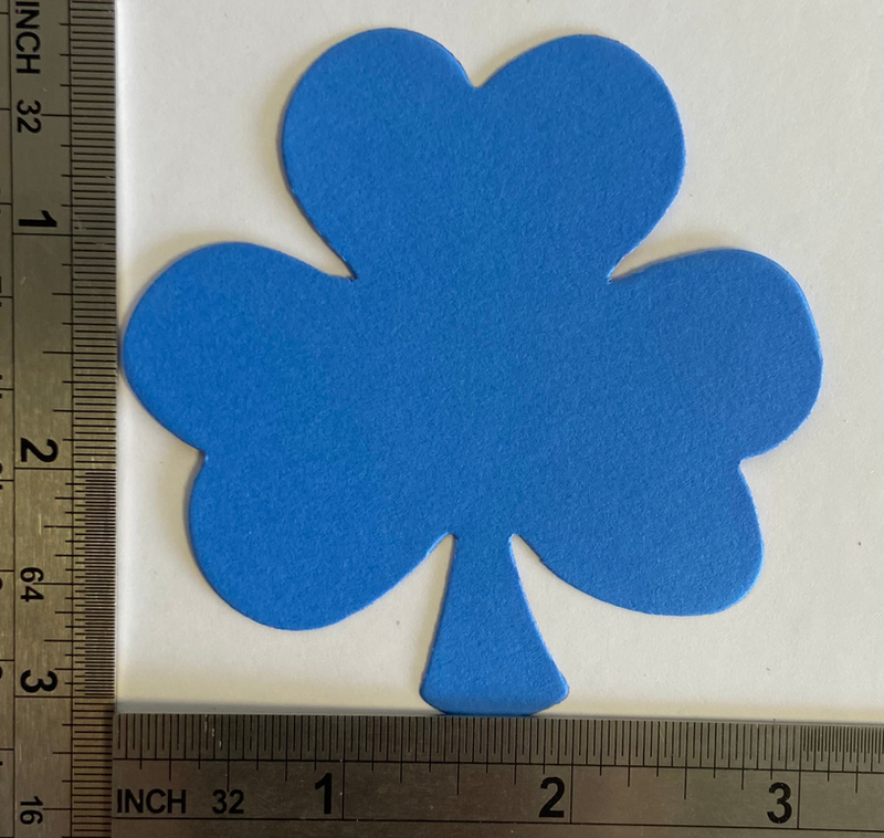 Blue felt shamrock cut-out with inches ruler for scale