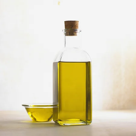 Argan oil bottle with amber liquid and cork stopper