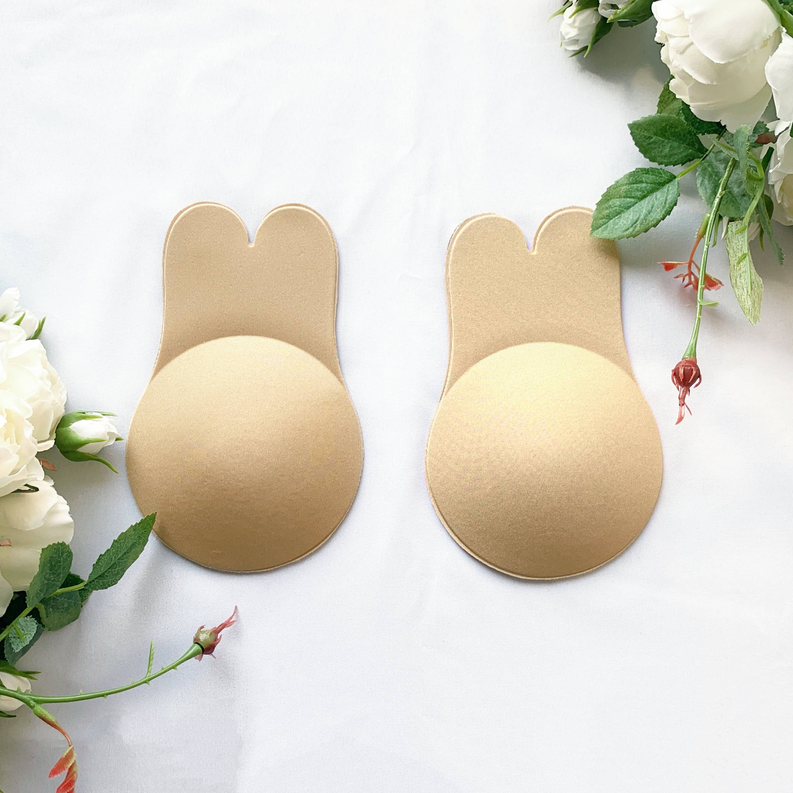 Beige bunny-shaped lift bra pads with textured surface, two pieces