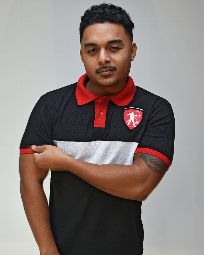 Black classic polo shirt with red collar, white stripe, and chest shield logo